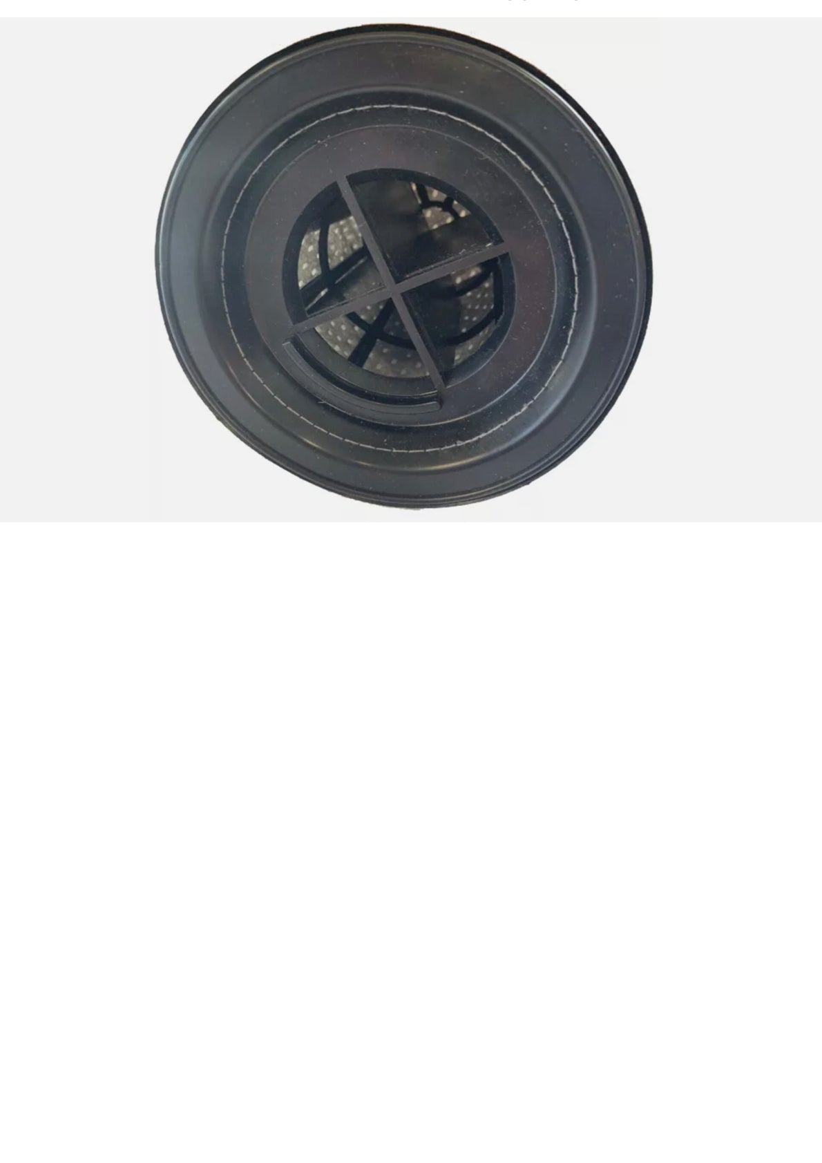 Black circular plastic object with a textured surface on a white background